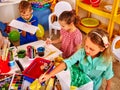 Group of children draws pictures in the small kindergarten.