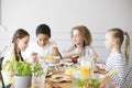 Group of children eating healthy dinner