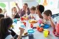 Group Of Children Eating Lunch In School Cafeteria