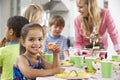 Group Of Children Enjoying Birthday Party Food At Table Royalty Free Stock Photo