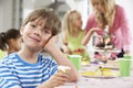 Group Of Children Enjoying Birthday Party Food At Table Royalty Free Stock Photo