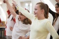 Group Of Children Enjoying Dance Lesson At Stage School Together