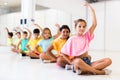 Group of children exercising during yoga class in fitness center - vakrasana pose Royalty Free Stock Photo