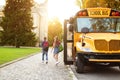 Group of children getting out the yellow retro school bus, Royalty Free Stock Photo