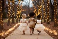 A group of children girls in evening dresses walk through the park together