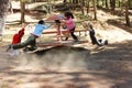 A group of children happily playing on a swing