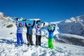 Group of children hold mountain ski in the air