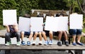 Group of children holding blank banner cover their face Royalty Free Stock Photo