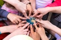 A Group Of Children Holds A Small Toy Globe Of The Earth