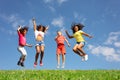 Group of children jump over blue sky and clouds Royalty Free Stock Photo