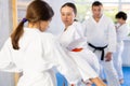 Group of children in kimono practicing karate in a sports gym. Martial arts training session Royalty Free Stock Photo