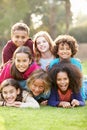 Group Of Children Lying On Grass Together In Park Royalty Free Stock Photo