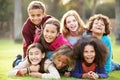 Group Of Children Lying On Grass Together In Park