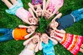 A group of children lying on the green grass in the Park. The interaction of the children. Royalty Free Stock Photo