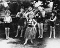 Group of children performing with instruments and one girl dancing the hula Royalty Free Stock Photo