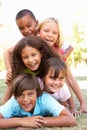 Group Of Children Piled Up In Park Royalty Free Stock Photo