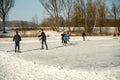 A group of children play ice hockey on a frozen lake Royalty Free Stock Photo