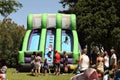 A group of children play on an inflatable slide.