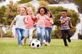 Group Of Children Playing Football With Friends In Park Royalty Free Stock Photo