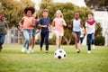 Group Of Children Playing Football With Friends In Park Royalty Free Stock Photo