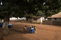 Group of children playing a game of checkers under a tree in the town of Nhacra in Guinea Bissau Royalty Free Stock Photo