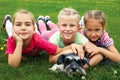 Group of children playing on green grass in spring park Royalty Free Stock Photo