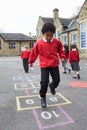 Group Of Children Playing Hopscotch In School Playground Royalty Free Stock Photo