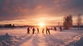 Group of children playing ice hockey on frozen lake in winter countryside.