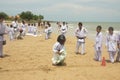 A group of children playing a sack race with helmet on (balap karung dengan helm), in Tlangoh beach.