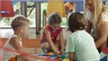 Group of children playing with schoolmaster