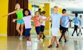 Group of children practicing vigorous jive movements in dance cl Royalty Free Stock Photo