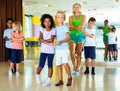 Group of children practicing vigorous jive movements in dance cl Royalty Free Stock Photo