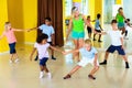 Group of children practicing vigorous jive movements in dance cl Royalty Free Stock Photo