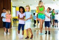 Group of children practicing vigorous jive movements in dance cl Royalty Free Stock Photo
