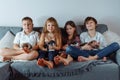 Group of children and puppies. Family, brothers and sisters are sitting on sofa and holding puppies. Friendship. Royalty Free Stock Photo