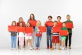 Group of children with a red banners isolated in white Royalty Free Stock Photo