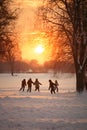 Group of children running away from camera, having fun outdoors.