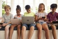 Group Of Children Sit On Window Seat And Use Technology Royalty Free Stock Photo