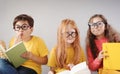 Group of children sitting indoors and reading books. Royalty Free Stock Photo