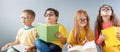 Group of children sitting indoors and reading books. Royalty Free Stock Photo