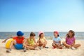 Group of children sitting on sand at sea beach. Summer camp Royalty Free Stock Photo