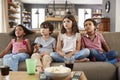 Group Of Children Sitting On Sofa Watching Television Together Royalty Free Stock Photo