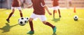 Group of a children soccer player on practice. Kids kicking and juggling balls on training Royalty Free Stock Photo