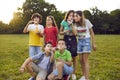 Children teens boys and girls posing in summer park and blowing bubbles having fun with friends Royalty Free Stock Photo