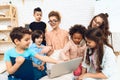 Group of children together with teacher are studying how to work with laptop. Royalty Free Stock Photo