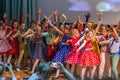 Group of children wearing bright colorful clothes and dancing on the stage. Royalty Free Stock Photo