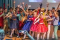 Group of children wearing bright colorful clothes and dancing on the stage. Royalty Free Stock Photo