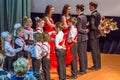 Group of children wearing formal suits and dancing on the stage. Pairs of dancing students. Royalty Free Stock Photo