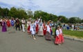 Group of children and women in Ukrainian traditional embroidered costumes walking in the municipal city park