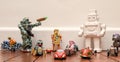 Group of childrens vintage and retro style toys including cars and robots on a wooden floor